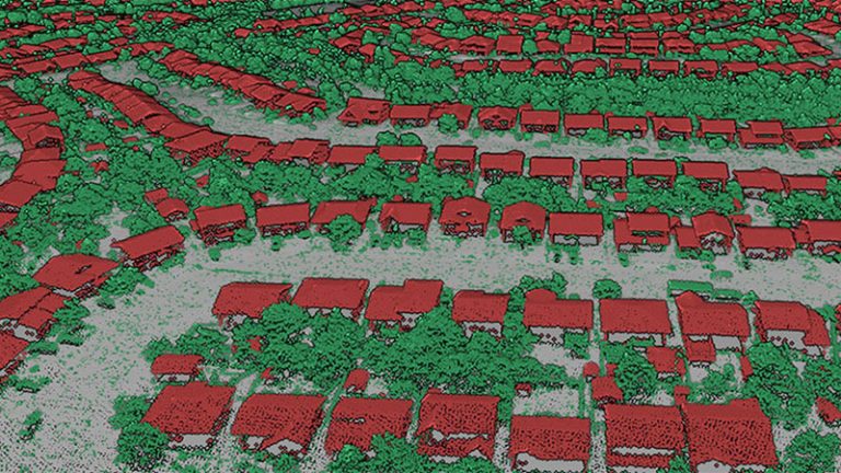 A 3D view of point clouds from above of a neighbourhood of houses and trees. Points corresponding to buildings, trees and the ground were colorized as red, green and gray, respectively.